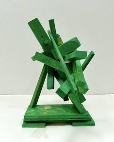 a green sculpture sitting on top of a white table