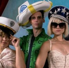 two women and a man are dressed up in costumes with hats on top of their heads