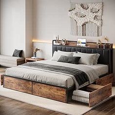 a large bed with drawers underneath it in a bedroom