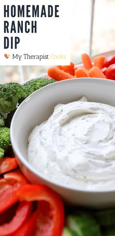 a white bowl filled with ranch dip surrounded by veggies