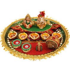 an elaborately decorated tray with ganeshi decorations