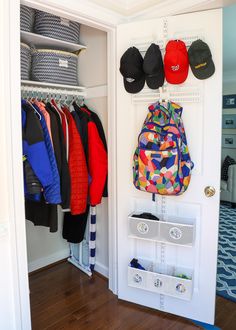 an organized closet with hats and shoes hanging on the wall, along with other items