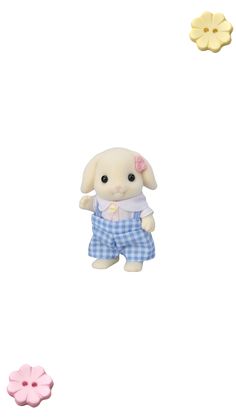 a small stuffed animal in blue and white checkered shorts next to two smaller buttons