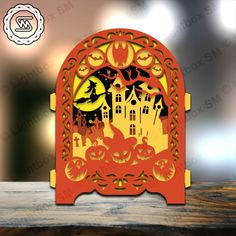 an orange and yellow paper cut out of a castle with pumpkins on the front