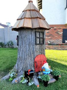 a small tree house sitting in the middle of a yard