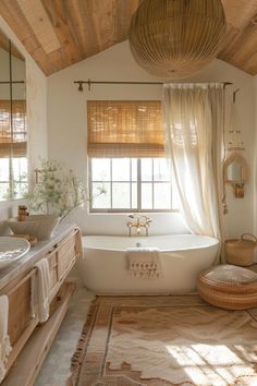 a bathroom with a tub, sink and mirror in it's center area is shown