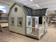 a tiny house is being built in a shop