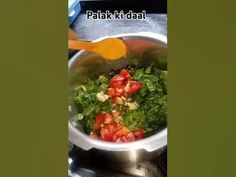 a pot filled with lots of vegetables on top of a stove