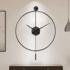 a clock is hanging on the wall next to a table