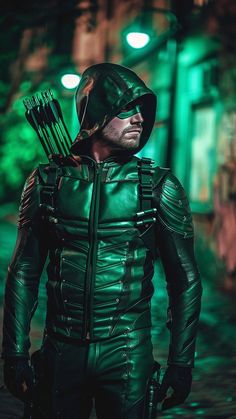 a man dressed in green is holding an arrow and looking at the camera while wearing a leather outfit