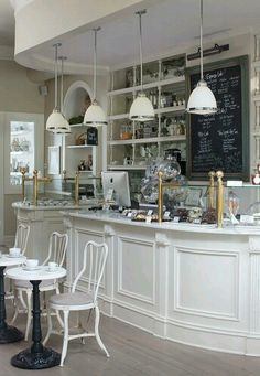 the interior of a restaurant with tables and chairs