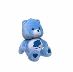 a blue teddy bear sitting on top of a white surface