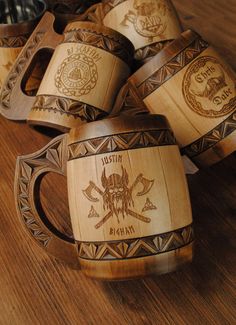 several wooden mugs with carved designs on them