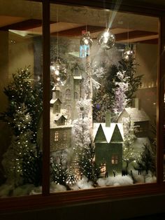 a window display with christmas trees and lights