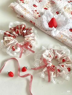 three pieces of fabric with bows and hearts on them sitting next to each other,