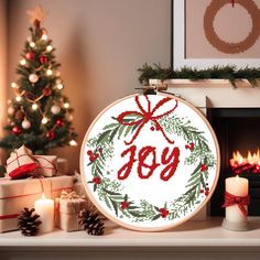 a cross stitch christmas ornament with the word joy in red and green on it