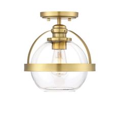 a light fixture with a clear glass globe on the bottom and gold trimmings