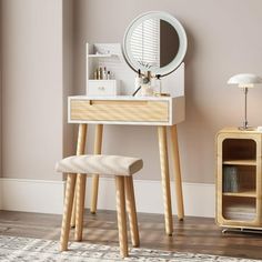 a white vanity table with a mirror and stool next to it on top of a hard wood floor