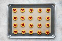 heart shaped cookies on a cookie sheet ready to be baked in the oven for valentine's day