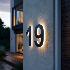 the number 19 is lit up on the side of a house