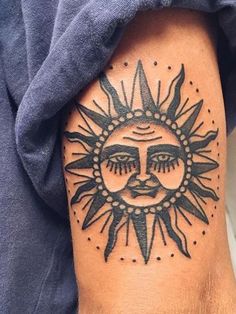 a sun tattoo on the arm