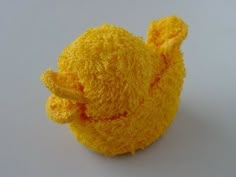 a yellow stuffed animal sitting on top of a white table