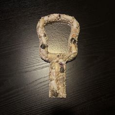 a piece of art that looks like an old fashioned keychain on a table