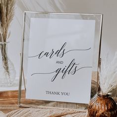 a sign that says cards and gifts is next to a vase with pamodia