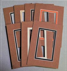 four pieces of brown paper with black and white lines on them are stacked together in the shape of rectangles