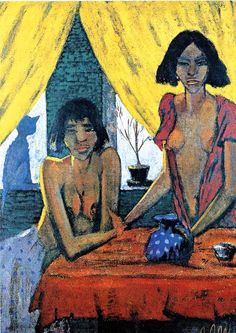 two women are sitting at a table in front of a yellow curtain and one is holding a blue vase