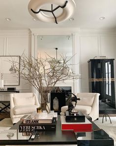 a living room filled with furniture and a tree in the middle of it's center