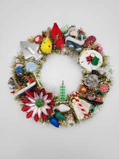 a christmas wreath made out of ornaments and tinsel