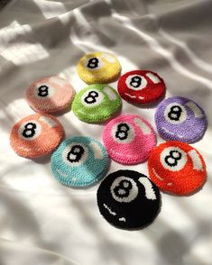 eight ball pool balls laid out on top of a white sheet with numbers in them