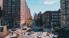 a city street filled with lots of traffic and tall buildings