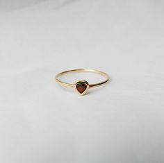 This Garnet Heart Ring brings love with you wherever you go. Show someone you love that you always have them in your heart. A great gift ring! Details: 14k gold (available in yellow, rose or white gold)Garnet heart measures about 3mm Free Shipping on Domestic Orders Materials: Garnet, 14k gold Need your ring bigger tha Garnet Heart Ring, 14k Gold Heart-shaped Solitaire Ring, Heart-shaped 14k Gold Ruby Promise Ring, 14k Gold Heart Ring With Birthstone For Promise, 14k Gold Heart-shaped Ruby Ring For Promise, 14k Gold Solitaire Heart Ring As Gift, Yellow Gold Stackable Heart Cut Rings For Promise, Yellow Gold Heart Birthstone Promise Ring, 14k Gold Solitaire Heart Ring For Valentine's Day