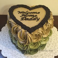 a heart shaped cake with the words welcome home daddy on it