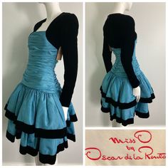 "Beautiful 1980s Miss O by Oscar de la Renta dress. Gorgeous blue taffeta with tule layered under each tier, black velvet sleeves and trim on skirt. This label is a step down from couture, and is constructed beautifully. Center back zipper closure, gathered bodice, this dress is quite heavy and full. There are a few faint small water marks on the skirt that are not very noticeable but mentionable. as this item has not yet been cleaned and  we have priced it accordingly. It's an absolutely stunning dress and really shows it quality and design Bust: 32\" Waist: 26\" Hip: 32-34\" Sleeve: 23.25\" Length: 39.25\" If you have any questions or would like more information about this listing, please don't hesitate to ask." 80s Fashion Formal Classy, 1980s Dresses Casual, Layerd Dress, Dynamic Clothes, 2000 Dresses, Short Dress Outfit, Layered Clothes, Blue Dress With Sleeves, Cute Blue Dress