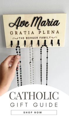 the catholic gift guide is shown with rosarys hanging from it