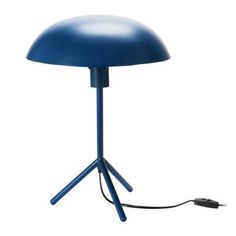 a blue table lamp sitting on top of a white floor