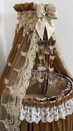 a canopy bed with lace and bows on the top is made out of brown material