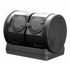 two black plastic containers sitting on top of a metal stand with four round holes in the middle