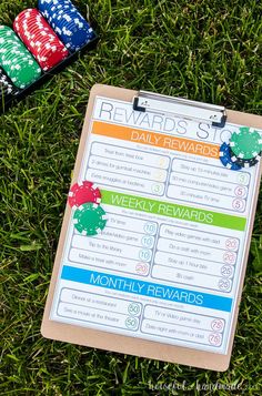 the reward list is laid out on the grass next to some chips and playing cards