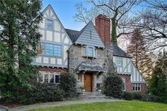 this is an image of a large house in the suburbs with stone and brick accents