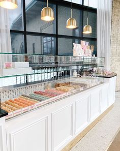 a display case filled with lots of different types of doughnuts and pastries