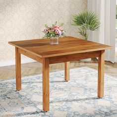 a wooden table sitting on top of a blue and white rug next to a potted plant