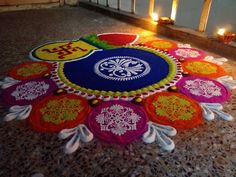 a colorfully decorated floor with candles and decorations on the ground for diwaling