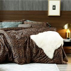 a leopard print comforter on a bed in a bedroom