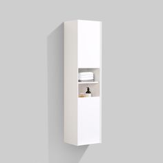 a white wall mounted cabinet with two shelves and one shelf is shown in the corner