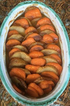 carrots and onions are cooked in the pot on the ground, ready to be eaten