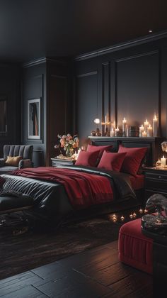 a bedroom with black walls and red bedding, candles on the nightstands in front of the bed